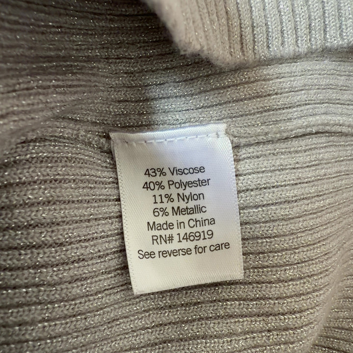 Tag view of cream ribbed knit sweater showing vertical ribbed pattern and fitted silhouette