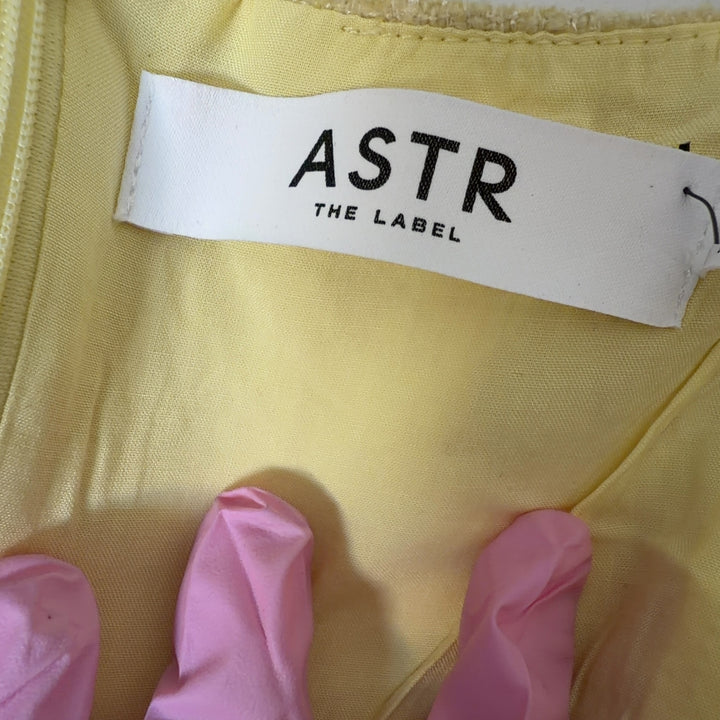 Yellow square neck sleeveless dress with patch pockets, back view