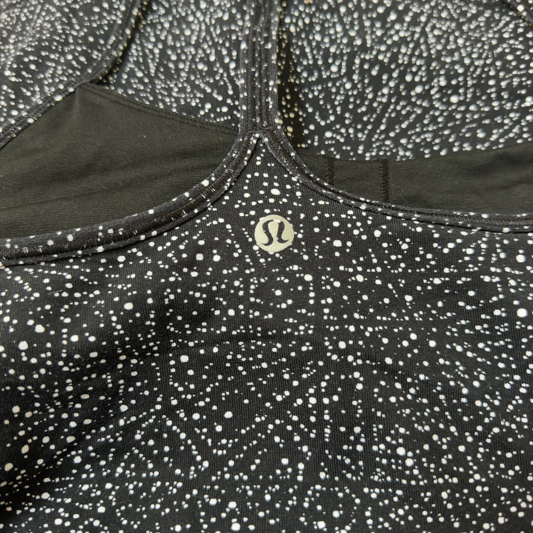Black speckled Lululemon camisole tank top, back view showing fitted silhouette and strap design