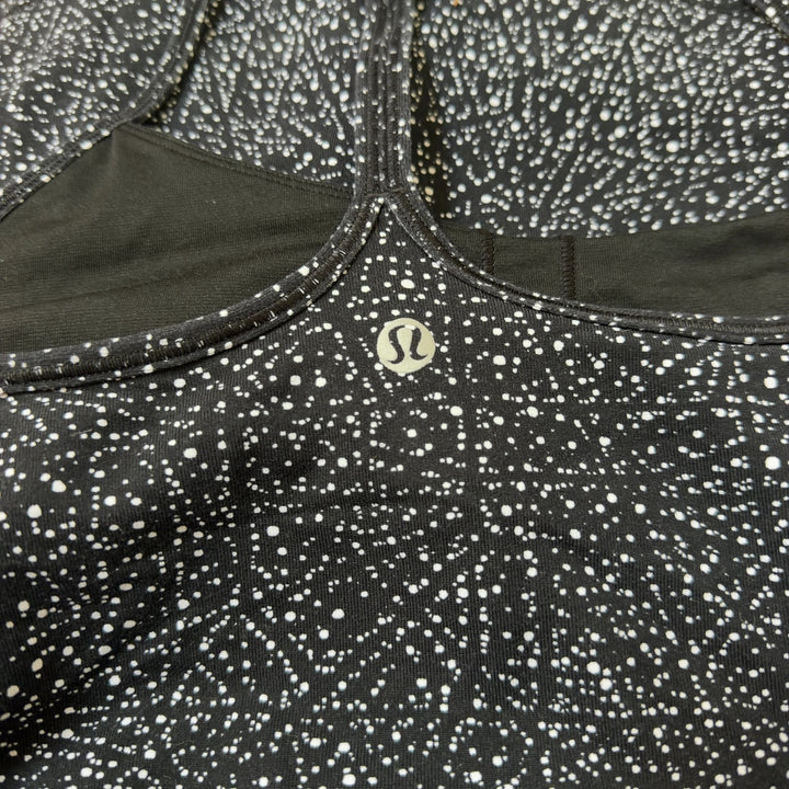 Black speckled Lululemon camisole tank top, back view showing fitted silhouette and strap design