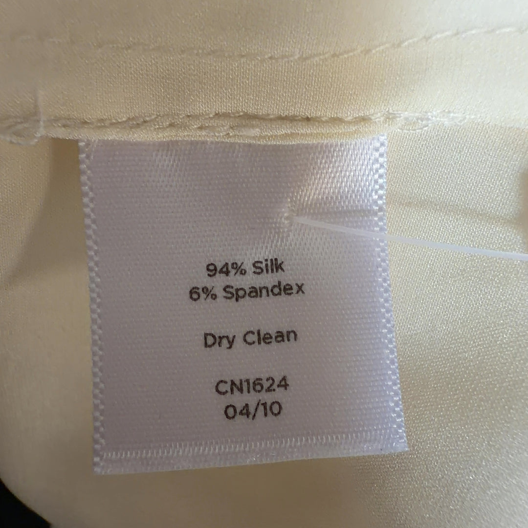 Cream silk sleeveless top back view, showing relaxed fit and center placket detail