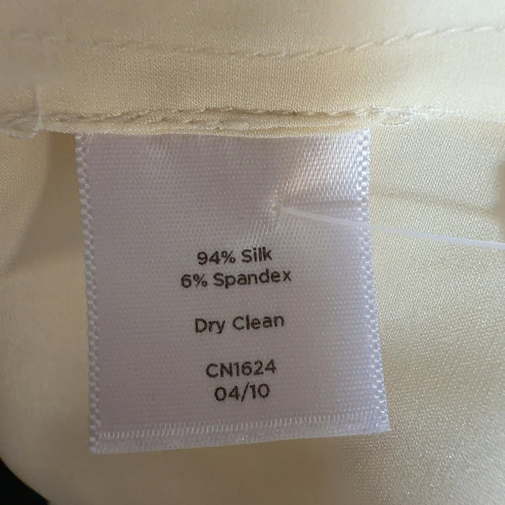 Cream silk sleeveless top back view, showing relaxed fit and center placket detail