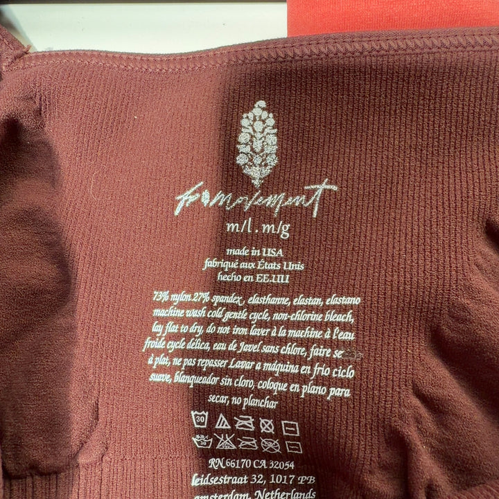 Tag view of burgundy ribbed sports bra tank top showing supportive construction and fit