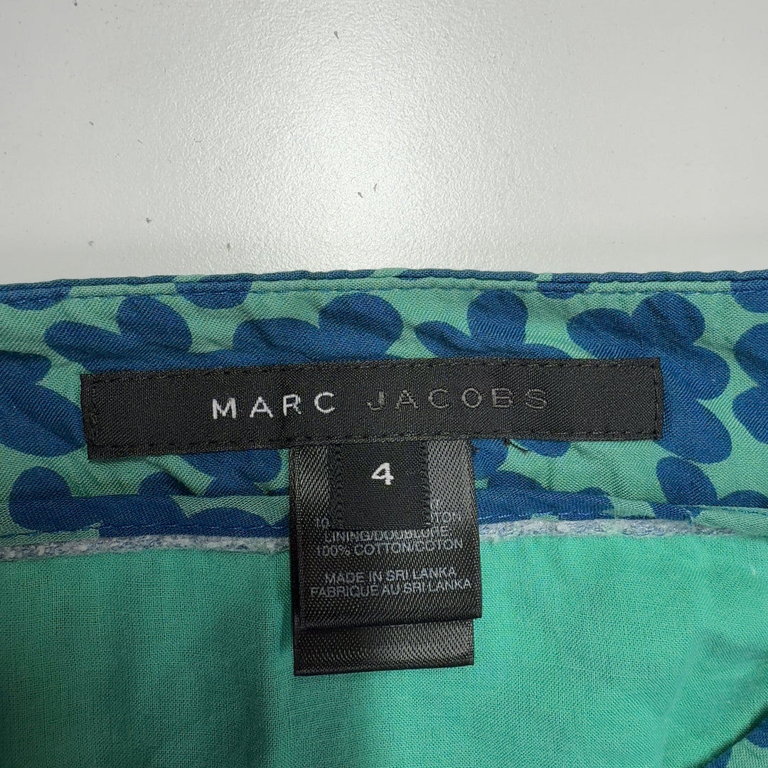 Tag view of Marc Jacobs teal floral A-line cotton skirt displaying elegant drape and botanical pattern