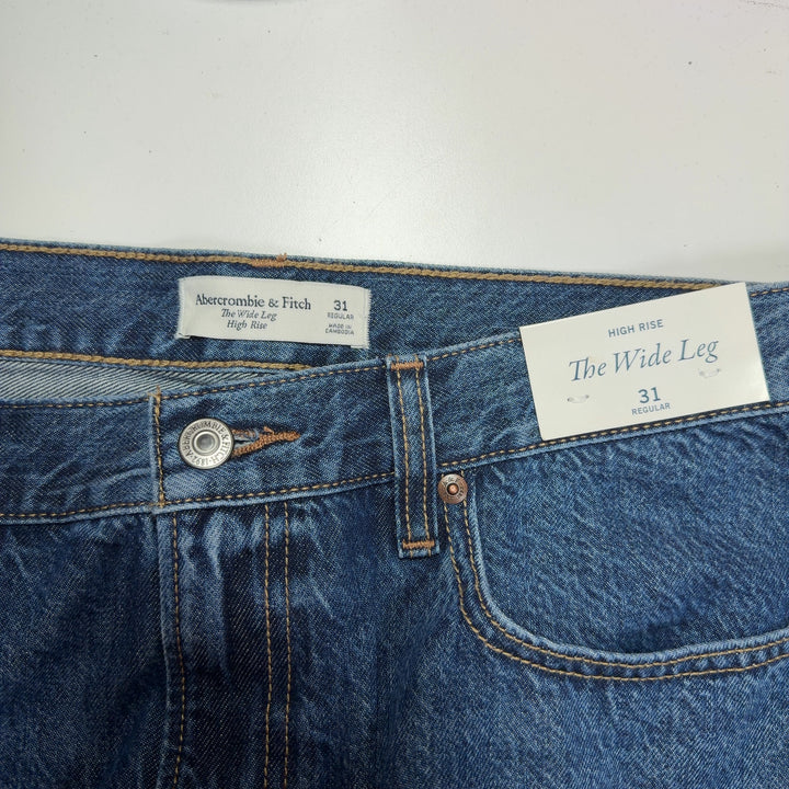Tag view of blue wide-leg denim jeans showing relaxed fit and classic denim construction