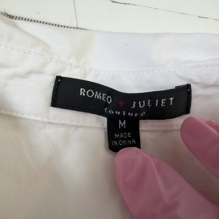 Tag view of white cotton ruched button-up shirt showing tailored fit and button closure
