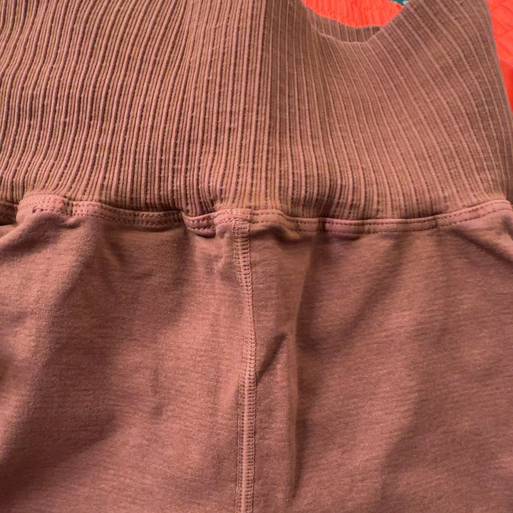 Rust ribbed high-waist activewear shorts back view, displaying high-waist cut and sleek design