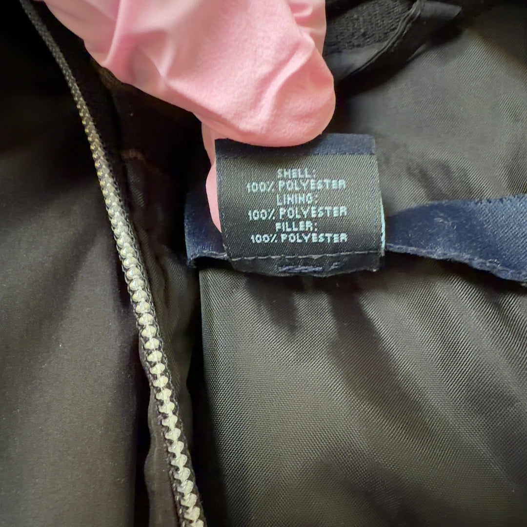 Black quilted puffer jacket back view showing structured silhouette and design