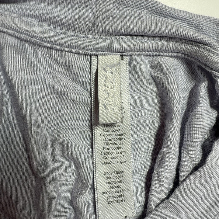 Gray cropped long sleeve top by Skims, back view displaying soft drape and contemporary design