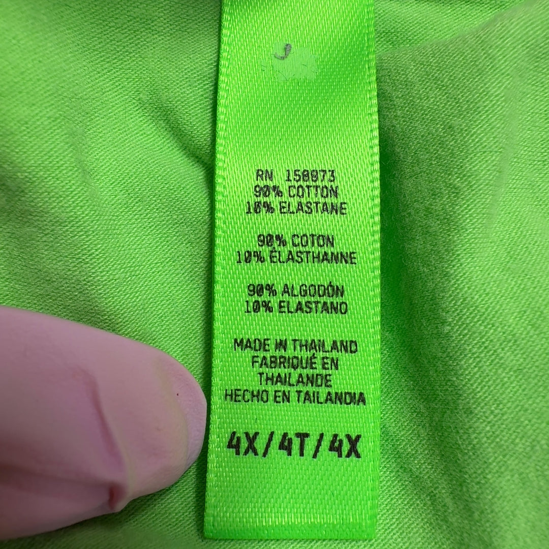 Tag view of woman wearing green cropped t-shirt by Skims with black fitted leggings