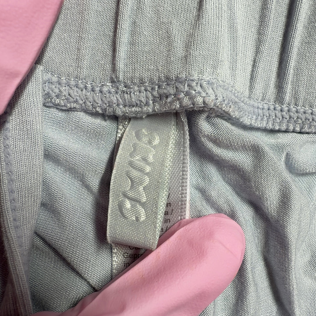 Gray wide leg pants back view, showing relaxed fit and draping silhouette