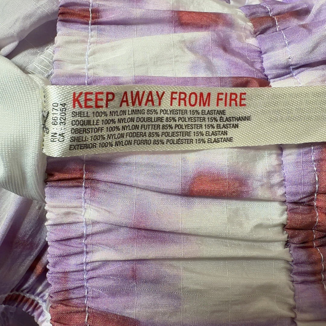 Tag view of pink tie dye athletic shorts with burgundy trim and side pockets by Free People Movement