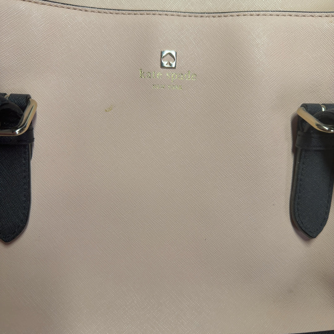 Kate Spade cream and black colorblock shoulder tote bag worn on shoulder, back view showing structured silhouette