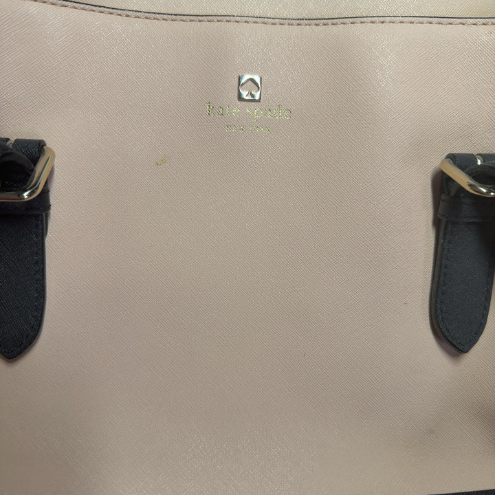 Kate Spade cream and black colorblock shoulder tote bag worn on shoulder, back view showing structured silhouette