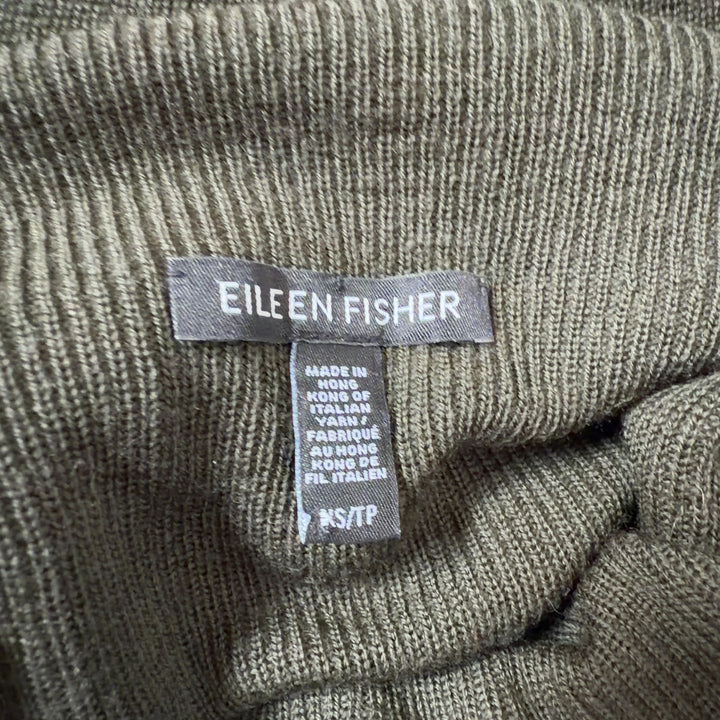 Olive green merino wool turtleneck sweater back view showing relaxed tunic length silhouette