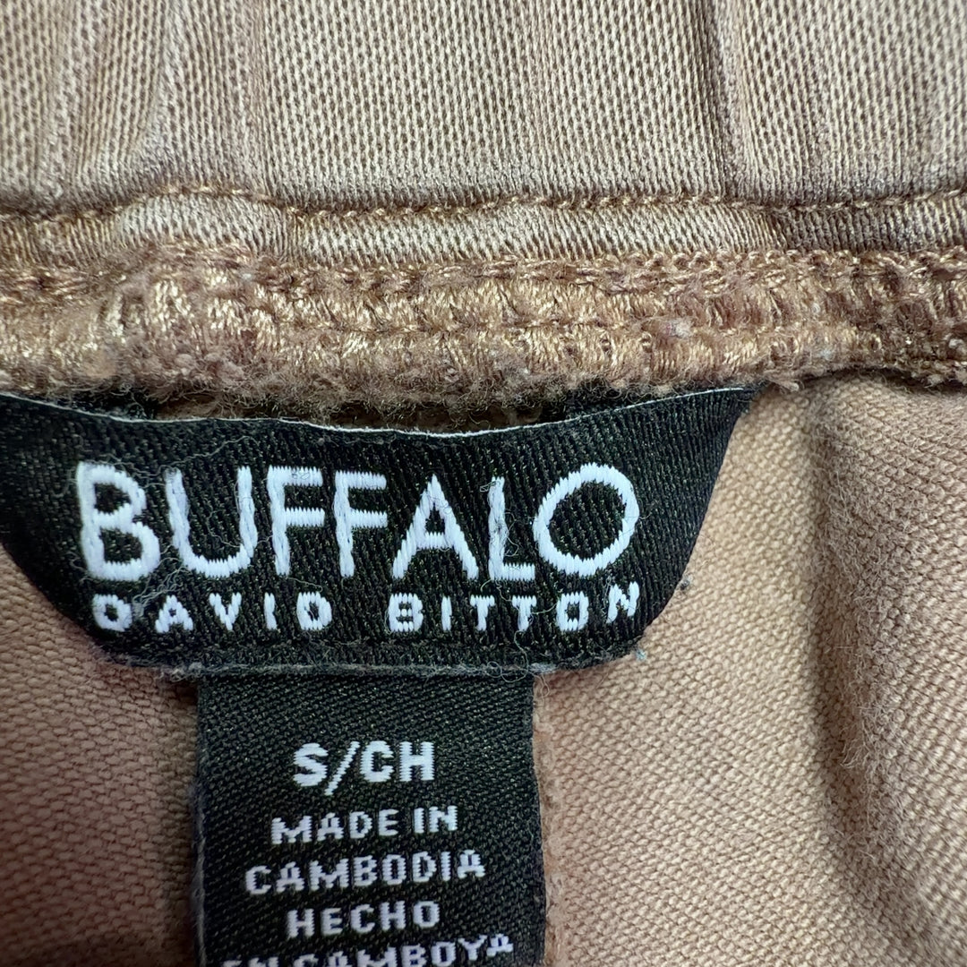 Beige cargo pants with rolled cuffs and side pockets, back view on model