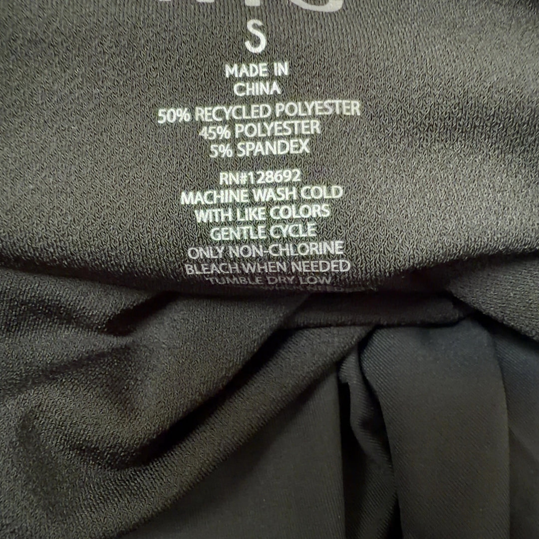Black ruched bubble hem dress back view showing fitted silhouette and bubble hem detail