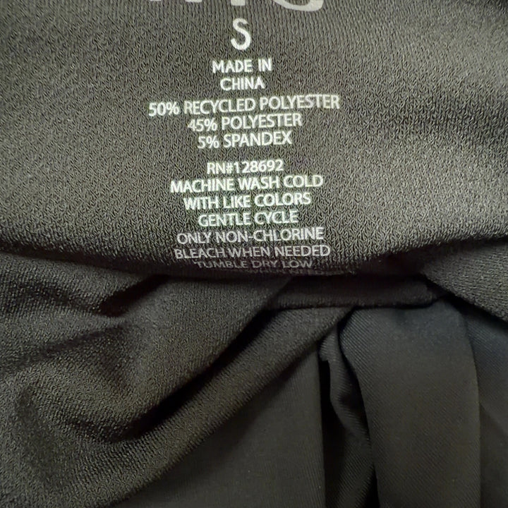 Black ruched bubble hem dress back view showing fitted silhouette and bubble hem detail