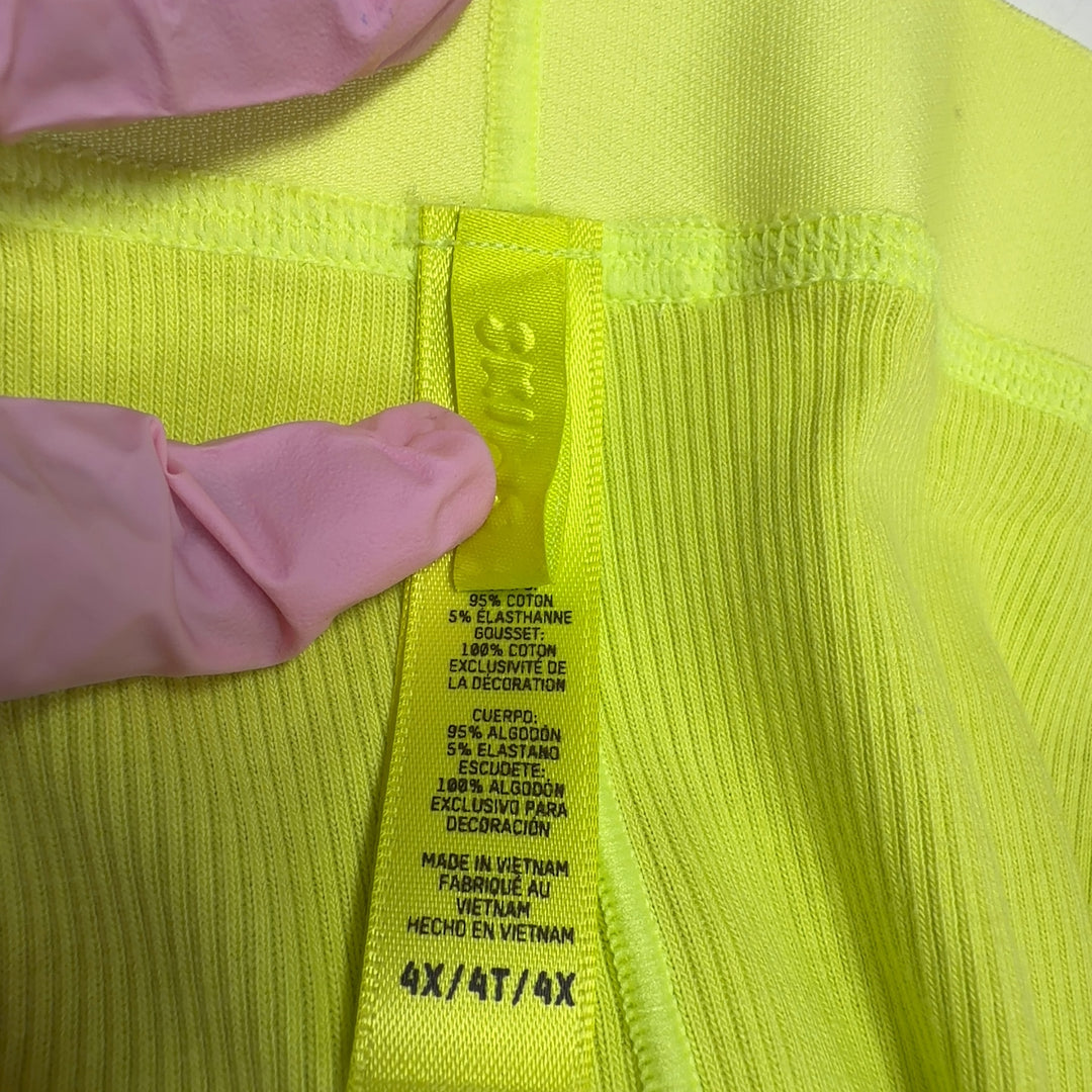 Tag view of neon yellow high-waisted stretch pants from Skims showing fitted silhouette