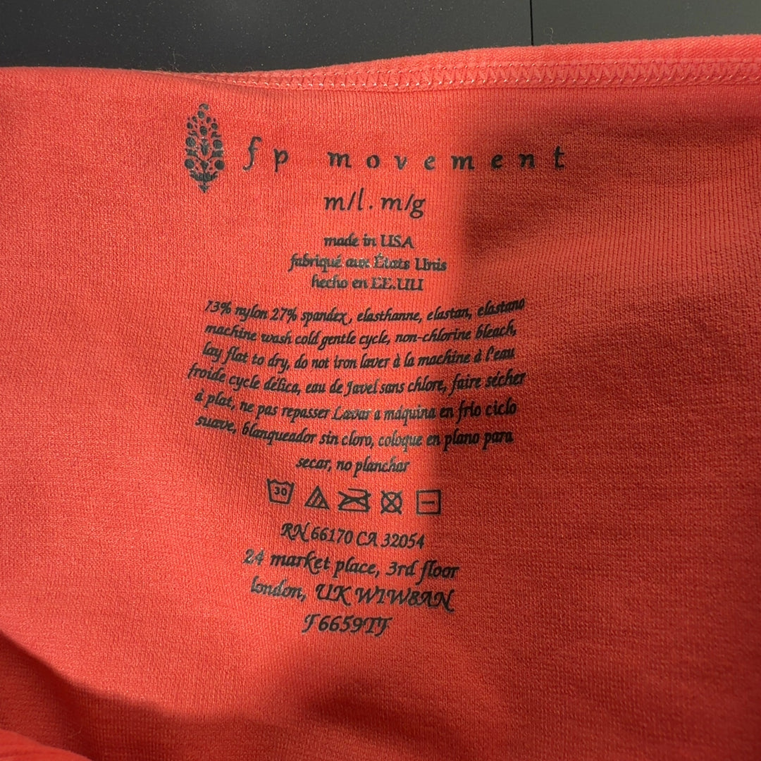 Coral ribbed crop tank top back view showing fitted silhouette and ribbed texture detail