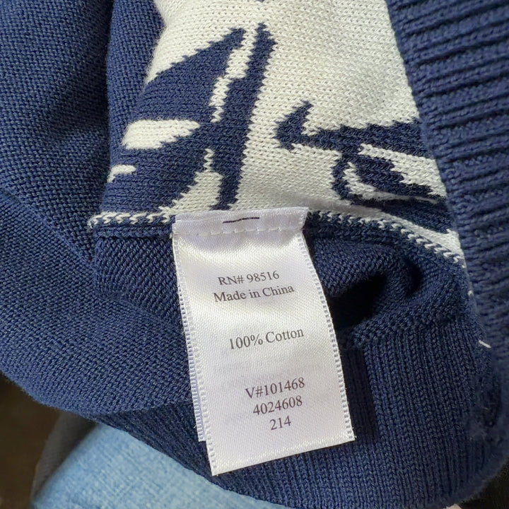Tag view of navy sailboat cardigan showing full pattern coverage and ribbed sleeve detail