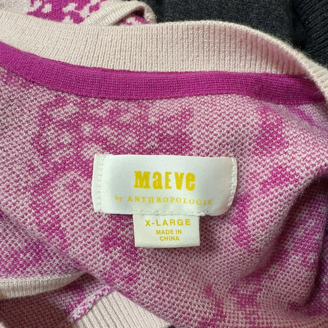 Tag view of pink elephant print knit vest showing sleeveless design and ribbed trim