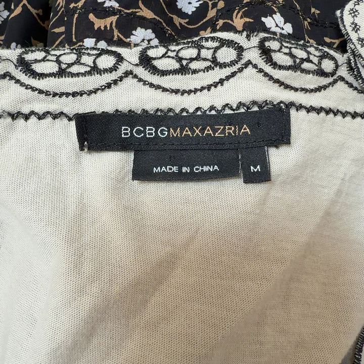 Tag view of cream embroidered cotton top showing empire waist and scalloped hem detail