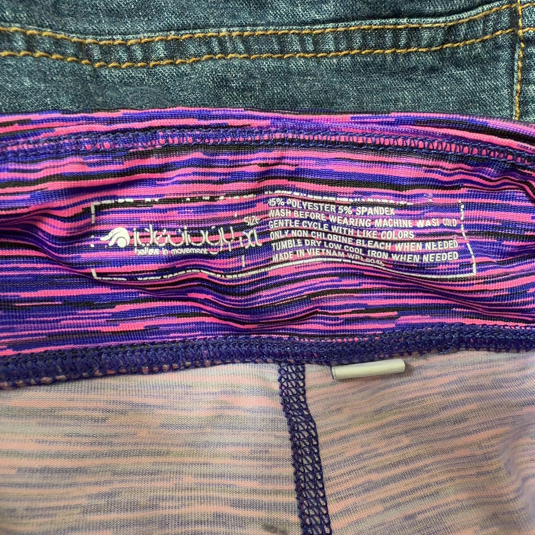Tag view of purple striped activewear skirt showing A-line silhouette and comfortable fit