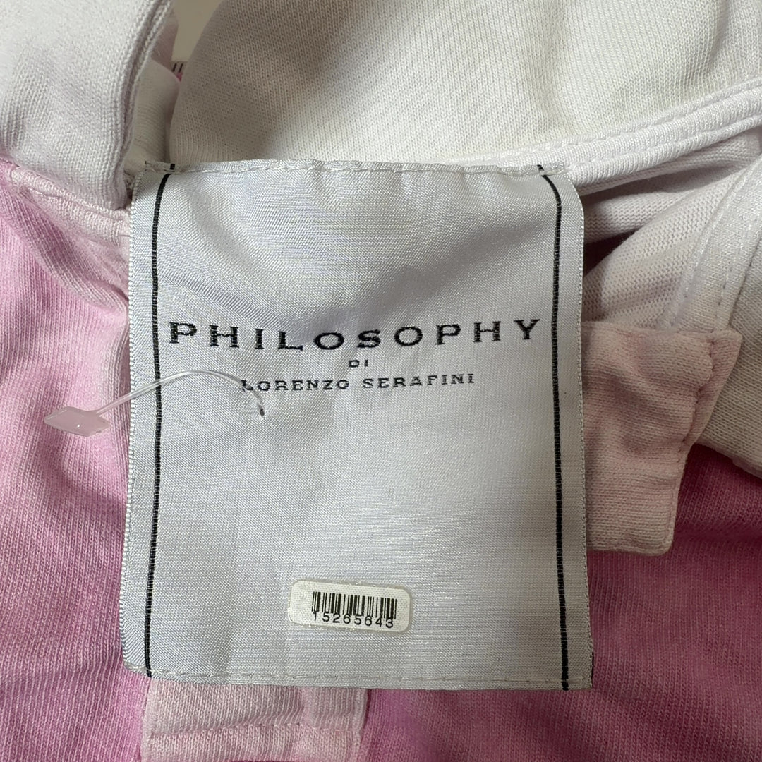 Tag view of pink and white cropped polo shirt showing relaxed fit and cropped length