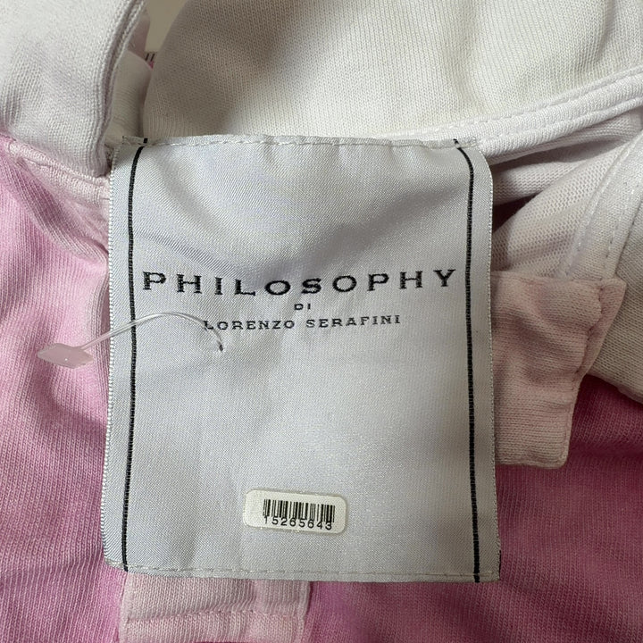 Tag view of pink and white cropped polo shirt showing relaxed fit and cropped length