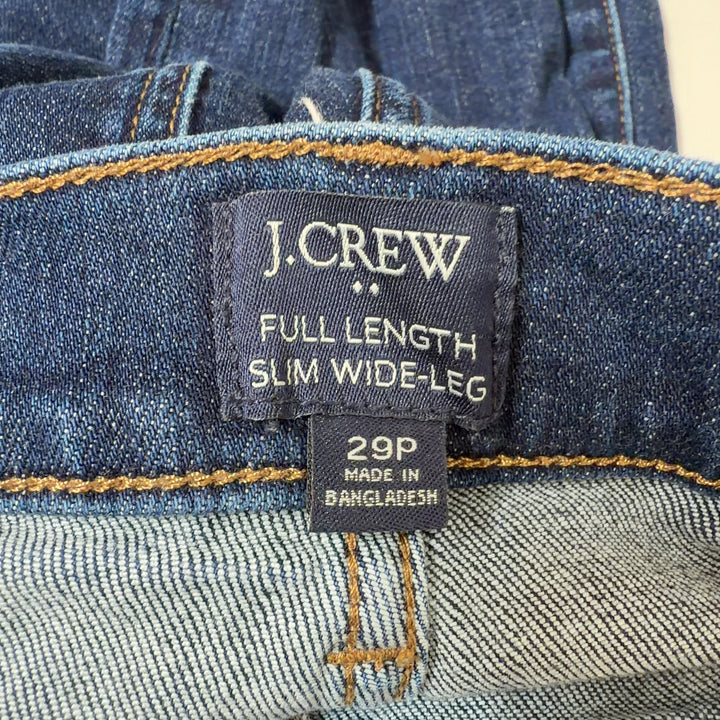 Tag view of dark blue wide-leg J.Crew jeans showing cropped ankle length and classic five-pocket design