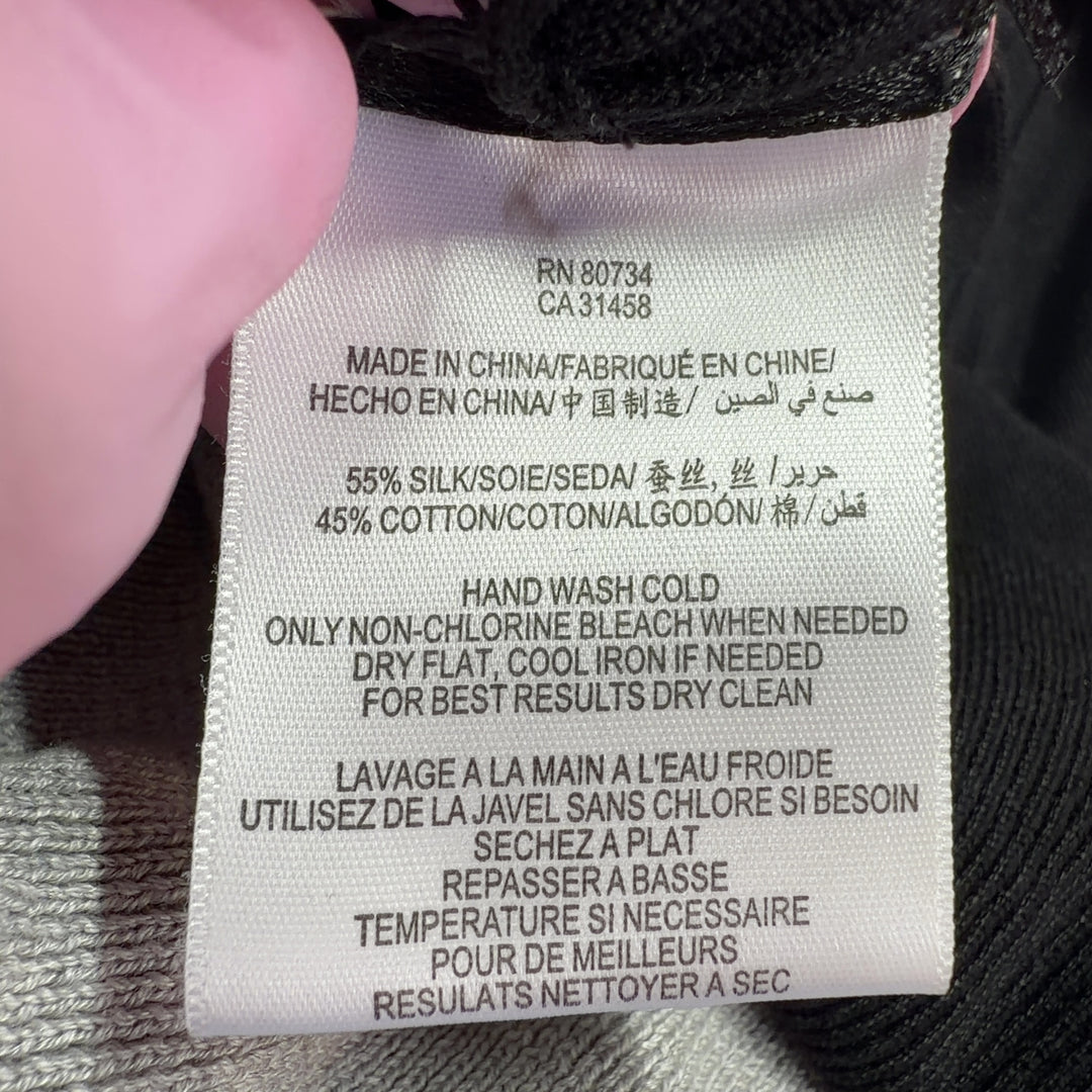 Tag view of gray and black BCBG MaxAzria cardigan showing relaxed fit and draping