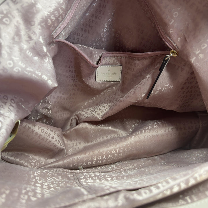 Tag view of cream quilted Kate Spade shoulder tote showing structured design and side pocket detail