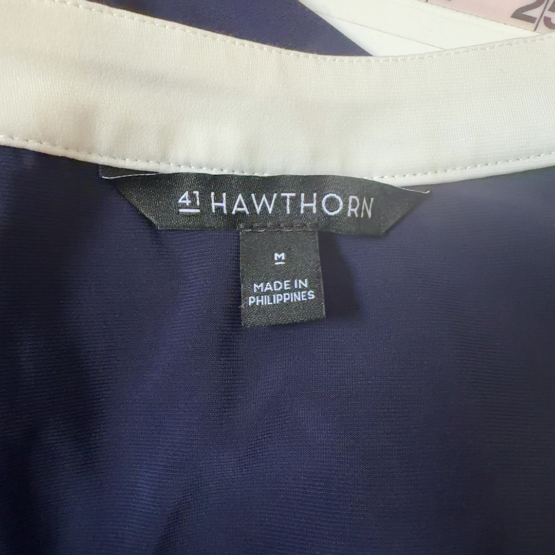 Navy sleeveless shift dress with white V-neck trim, back view