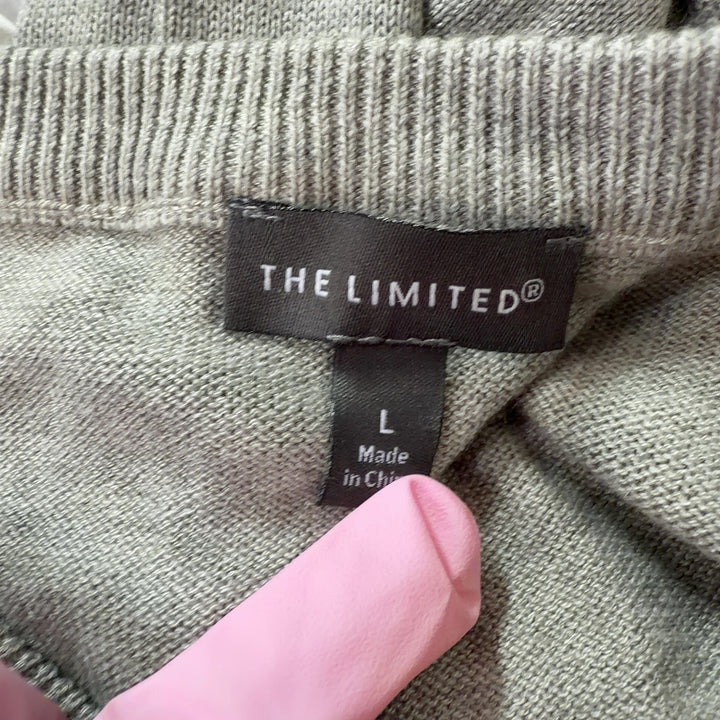 Tag view of beige knit pullover sweater showing clean silhouette and relaxed fit