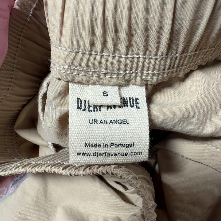 Beige cargo pants with drawstring waist and functional pockets, back view on model