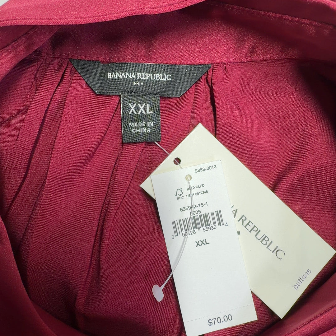 Burgundy button-up cap sleeve blouse, back view on model wearing black leggings