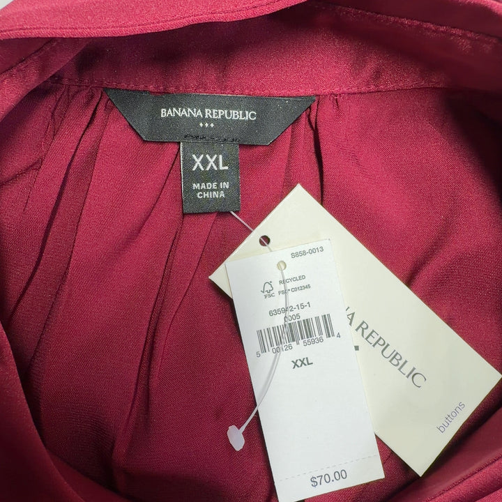 Burgundy button-up cap sleeve blouse, back view on model wearing black leggings