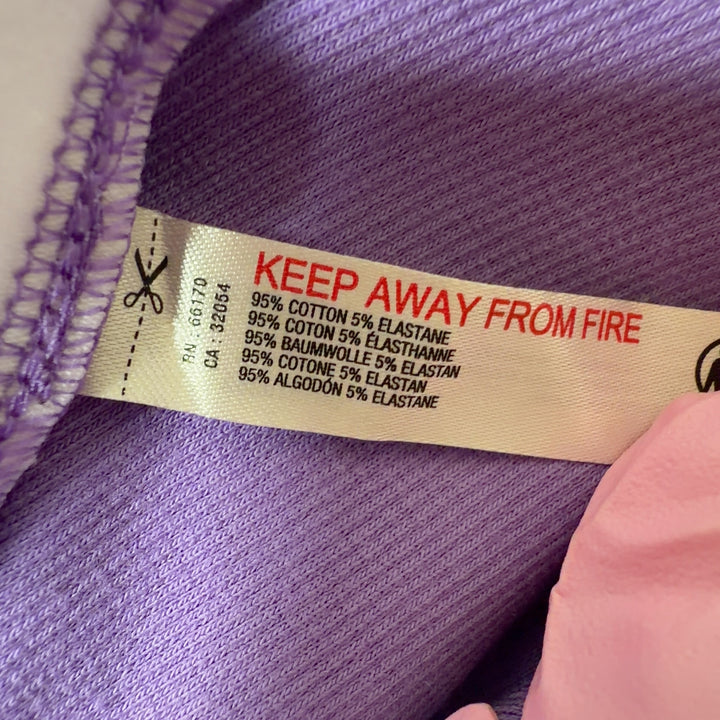 Tag view of purple sleeveless tank top showing fitted silhouette and V-neckline