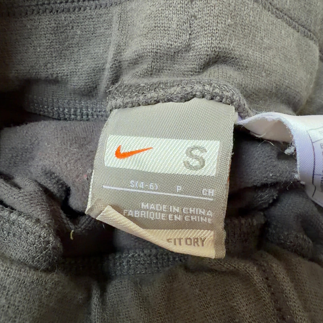 Tag view of gray and pink Nike athletic shorts showing side pink accents and athletic fit
