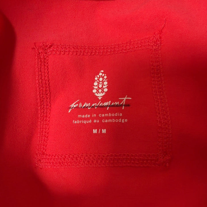 Red athletic tank top with black side panels, back view