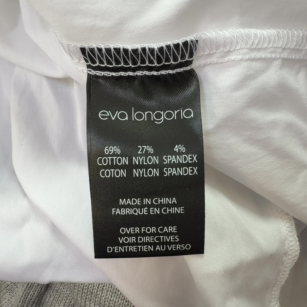 White button-up collared shirt back view, showing relaxed fit and length