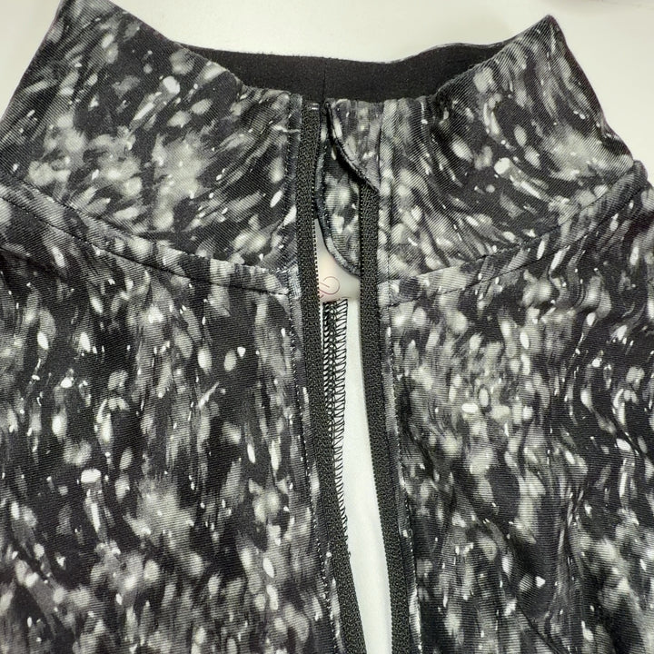 Calia gray speckled quarter-zip activewear top back view, showing fitted silhouette and long sleeves