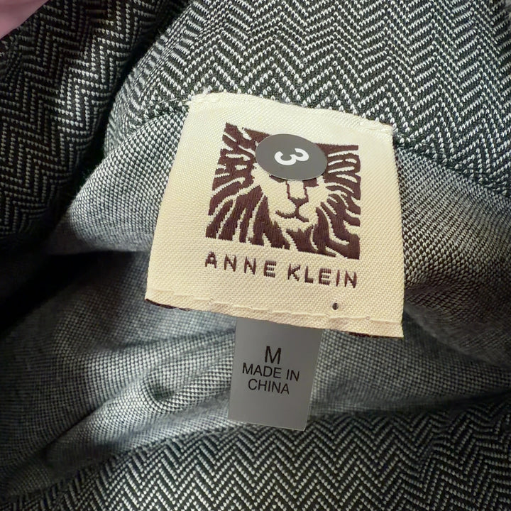 Tag view of gray wool blend cape jacket showing asymmetrical hemline and flowing draped design
