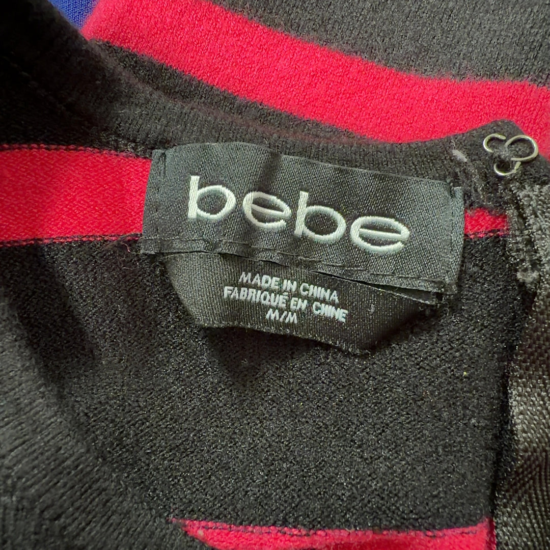 Red and black striped Bebe knit dress with sleeveless design and fitted back view
