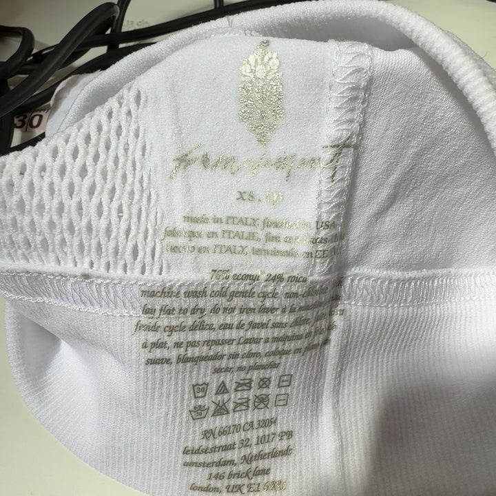 White mesh cutout sports bra with racerback design, back view on model
