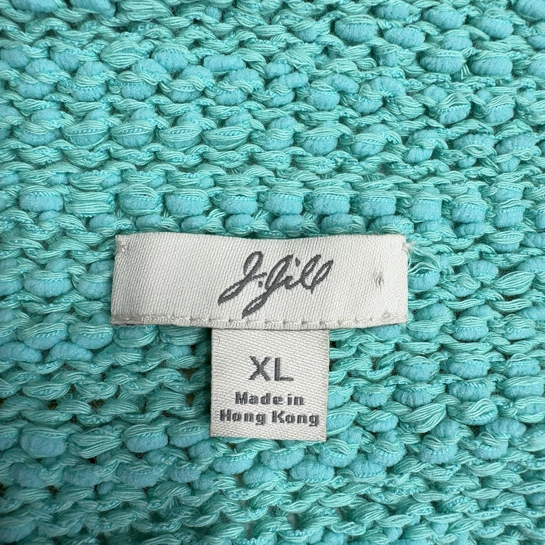 Tag view of mint green hooded knit sweater showing relaxed silhouette and rolled cuffs