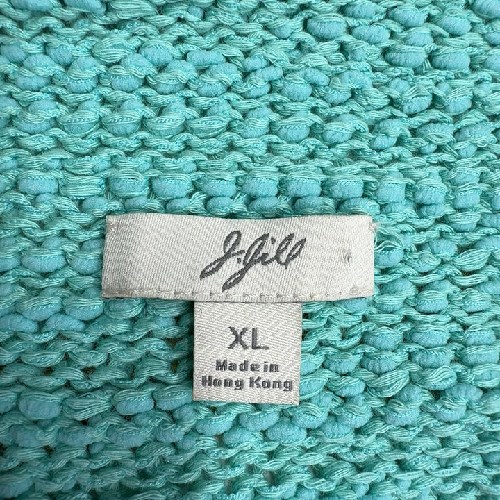 Tag view of mint green hooded knit sweater showing relaxed silhouette and rolled cuffs