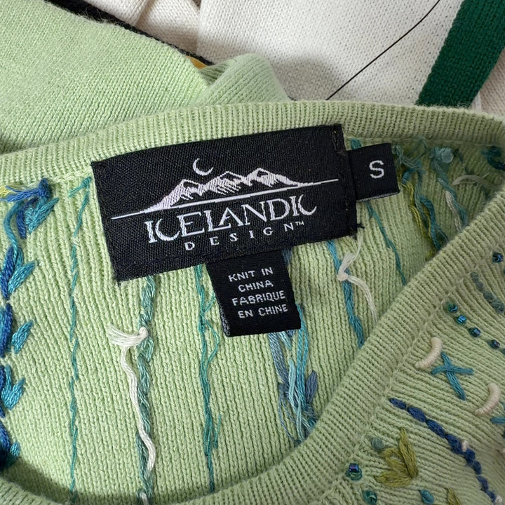 Tag view of lime green embroidered cardigan showing full-zip closure and embroidered hem details