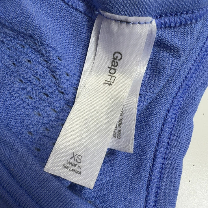 Periwinkle blue racerback tank back view showing fitted silhouette and side ruching
